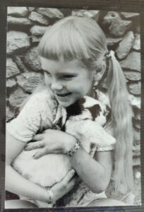 Girl holding baby goat
