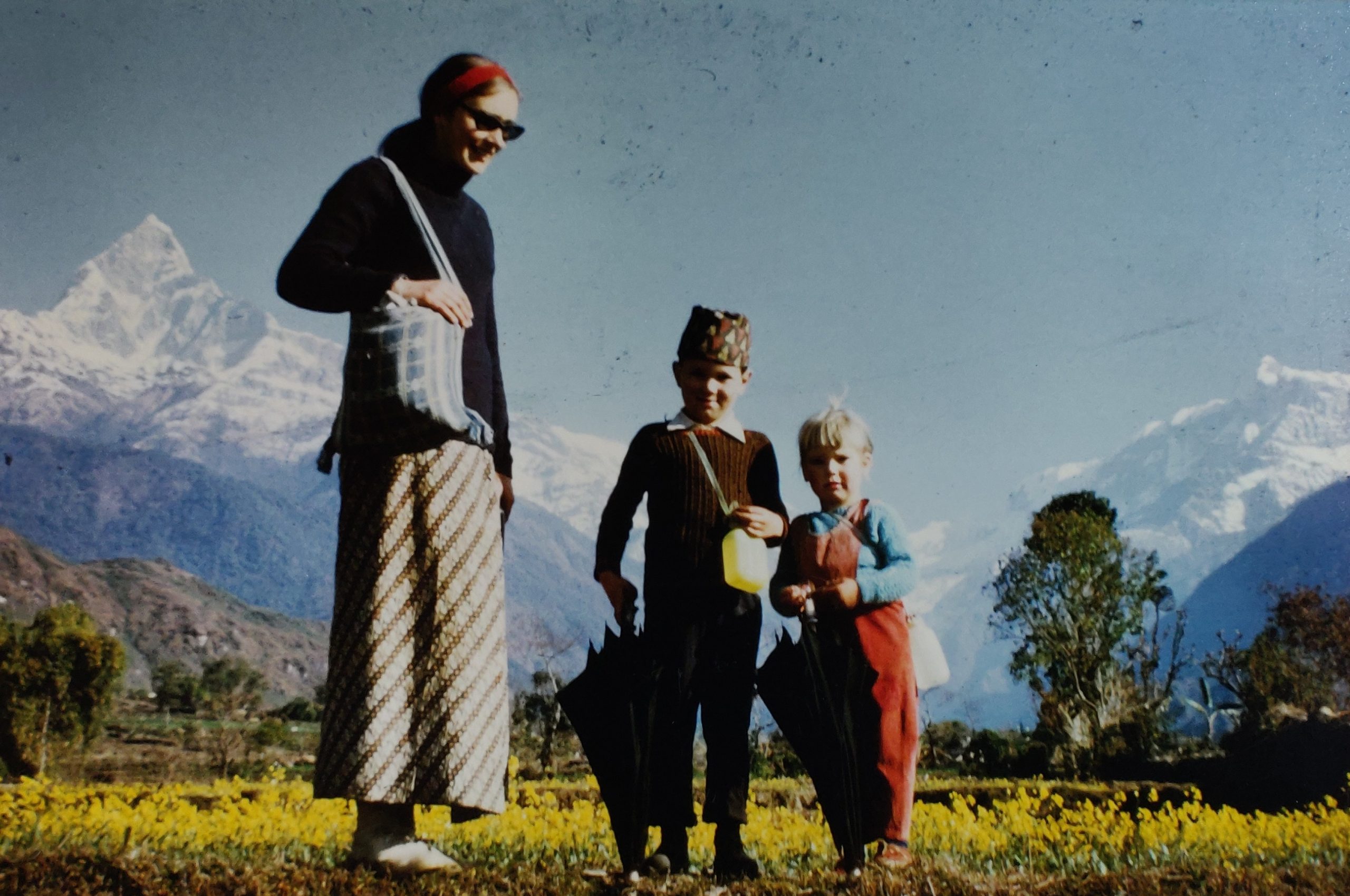 Mother and two children in front of Machapuchare, Nepal