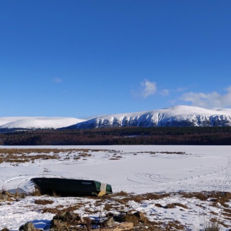 Boats on frozen Loch Insh