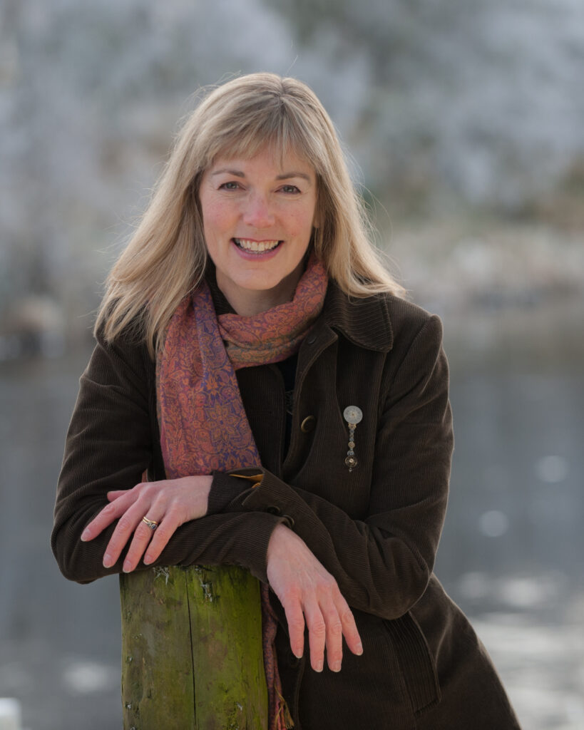 Photo of Merryn Glover leaning on a post by the River Spey - Credit Stewart Grant