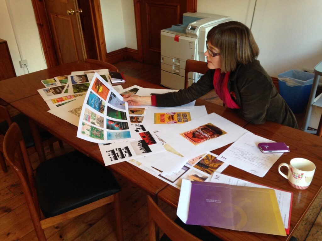 Merryn Glover looking at mood boards for her novel A House Called Askival